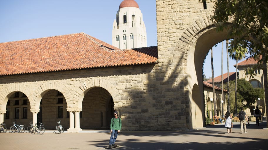A shot of Stanford's main quad with a student skateboarding