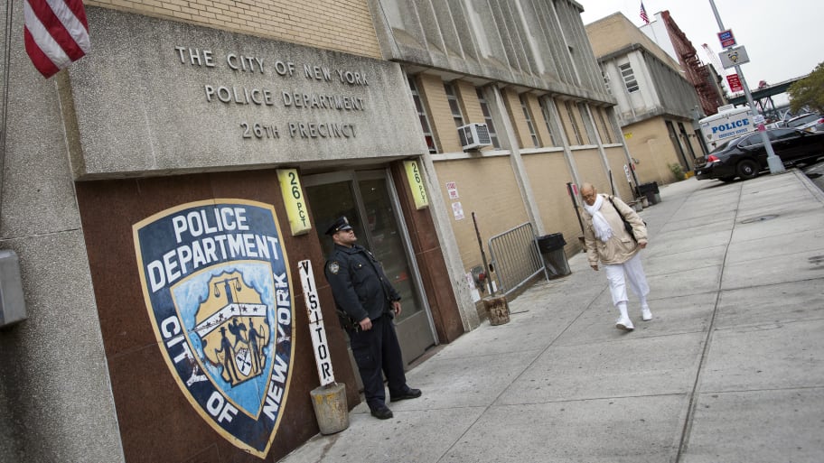A New York City police officer stands in front of the 26th Precinct in New York, October 25, 2012.
