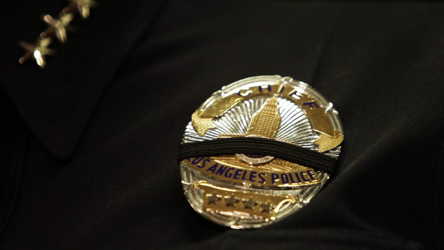 An LAPD badge with a black band stretched across.
