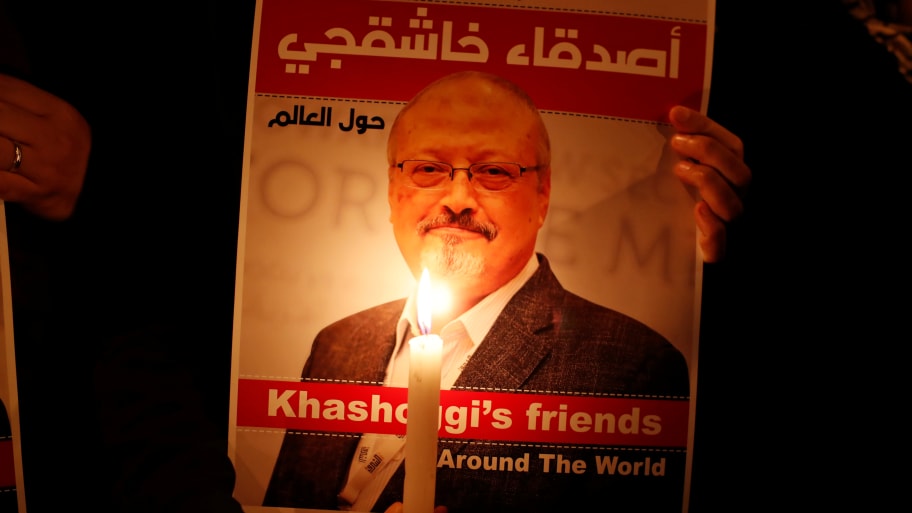 A demonstrator holds a poster with a picture of Saudi journalist Jamal Khashoggi outside the Saudi Arabia consulate in Istanbul, Turkey