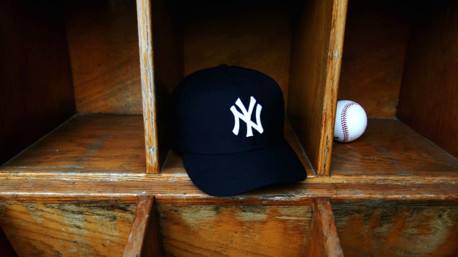 A New York Yankees cap and a baseball