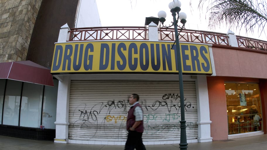 A man walks past a closed down store at the Revolucion Avenue in the border city of Tijuana May 13, 2008.