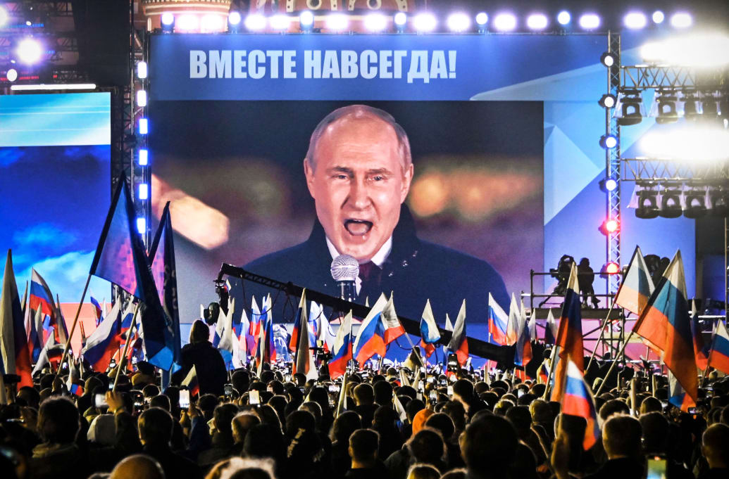 Russian President Vladimir Putin is seen on a screen set at Red Square as he addresses a rally and a concert marking the annexation of four regions of Ukraine Russian troops occupy in Moscow on September 30, 2022. 