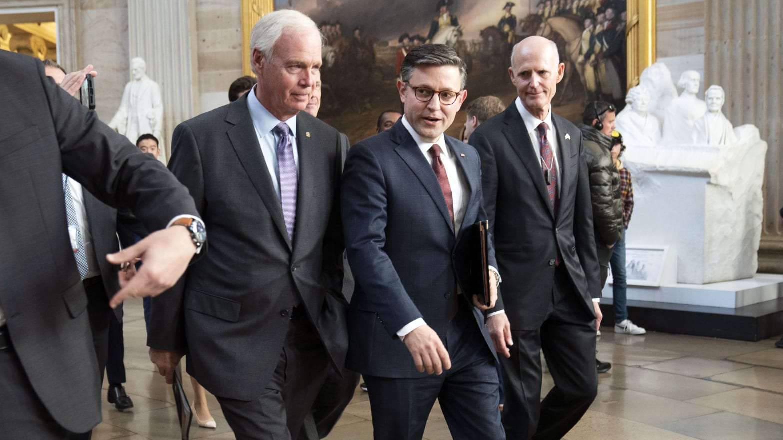 Speaker of the House Mike Johnson walks with colleagues