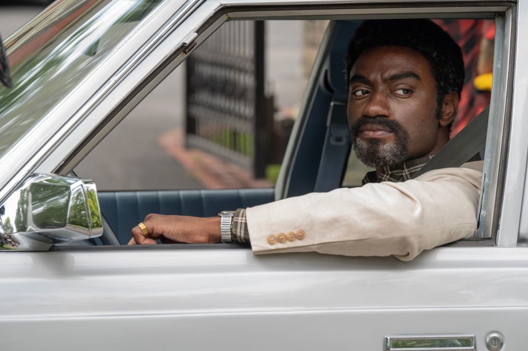 Jelani Alladin sits in a car in a still from ‘Fellow Travelers’
