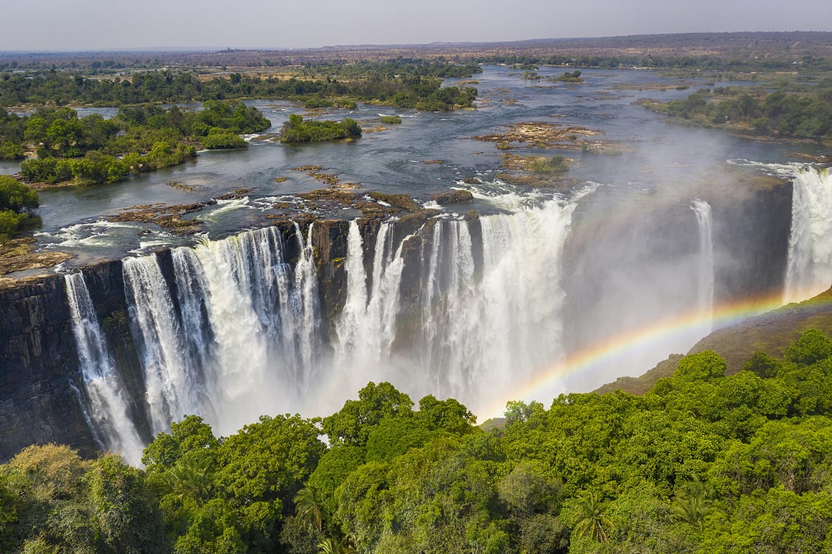 Aerial view of Victoria Falls with a large rainbow