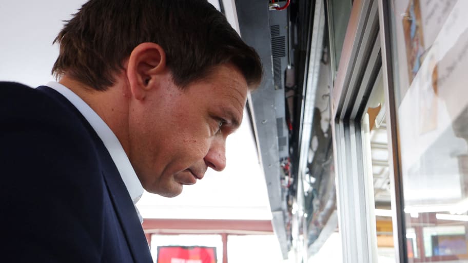 Ron DeSantis stares forward while ordering food in New Hampshire.