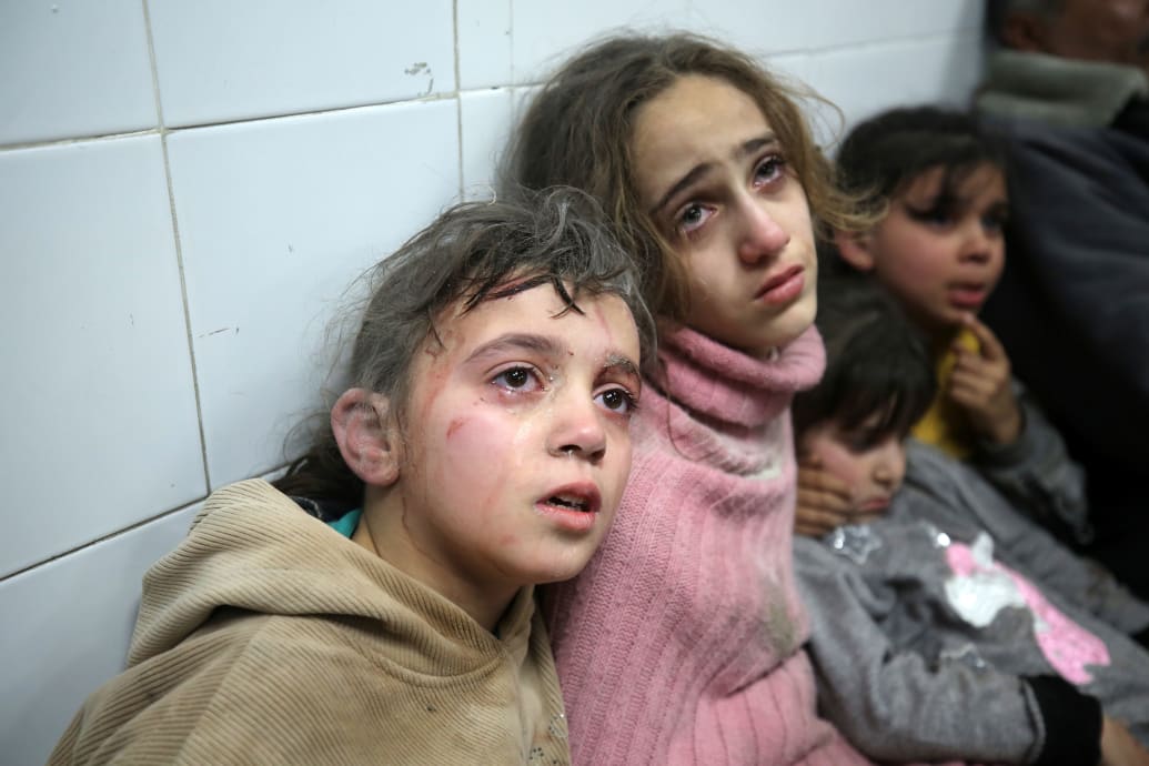 Wounded Palestinian children cry as they sit in a hospital in Gaza