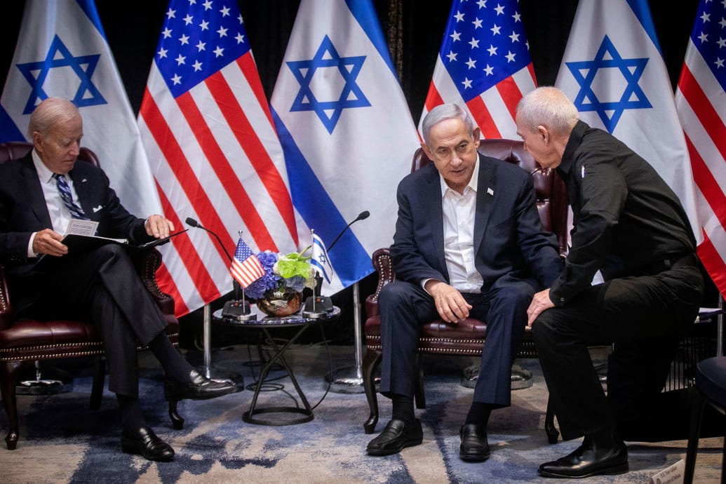 A picture of Benjamin Netanyahu sitting in a chair next to Joe Biden.