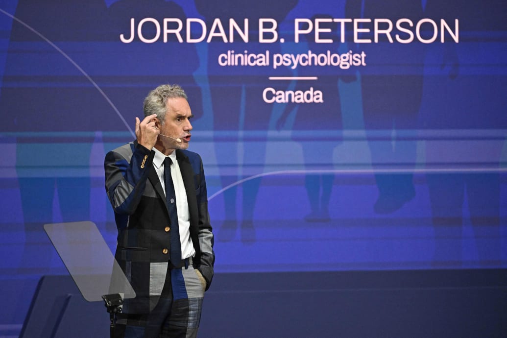 A picture of Jordan Peterson speaking on a stage