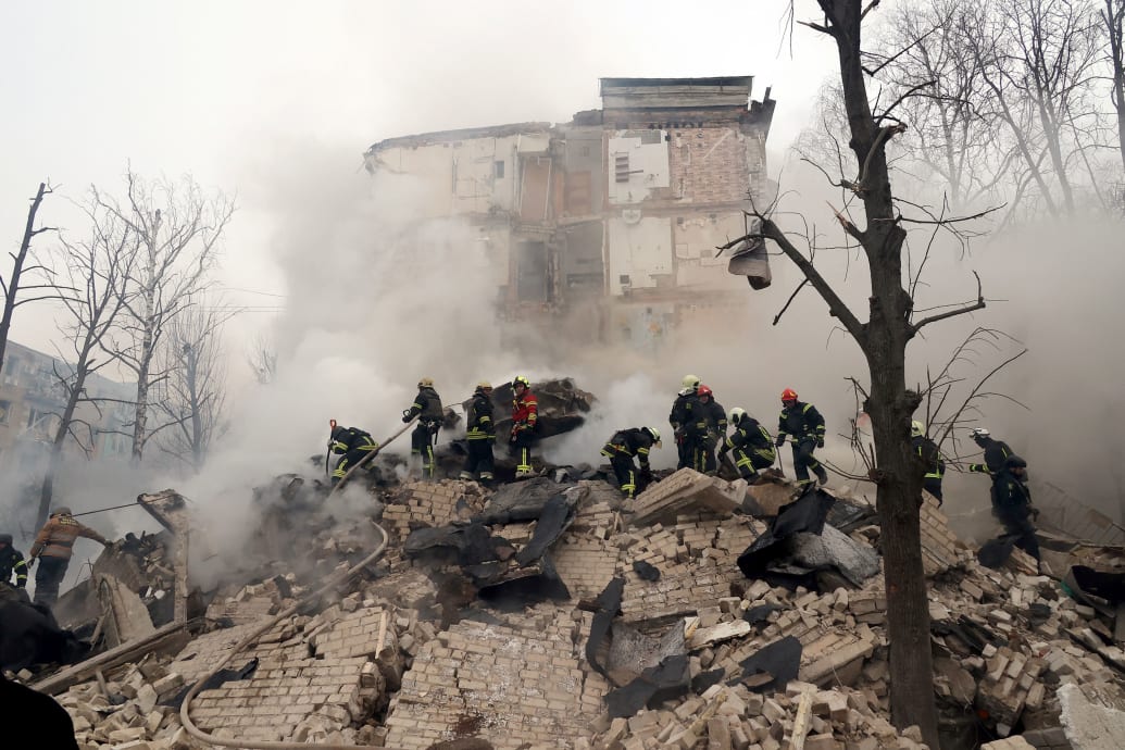 A photo of rescuers searching for people under rubble in Ukraine. 