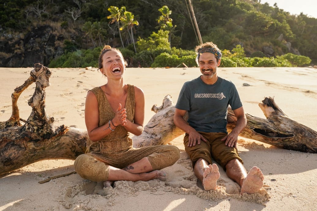 Parvati Shallow sits and laughs with Ethan Zohn in a still from 'Survivor: Winners at War'