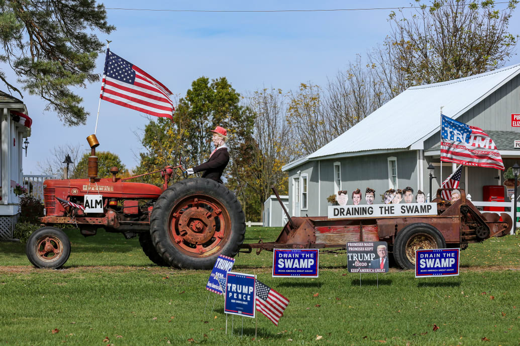 A picture of a rural home with American flags and pro Donald Trump memorabilia