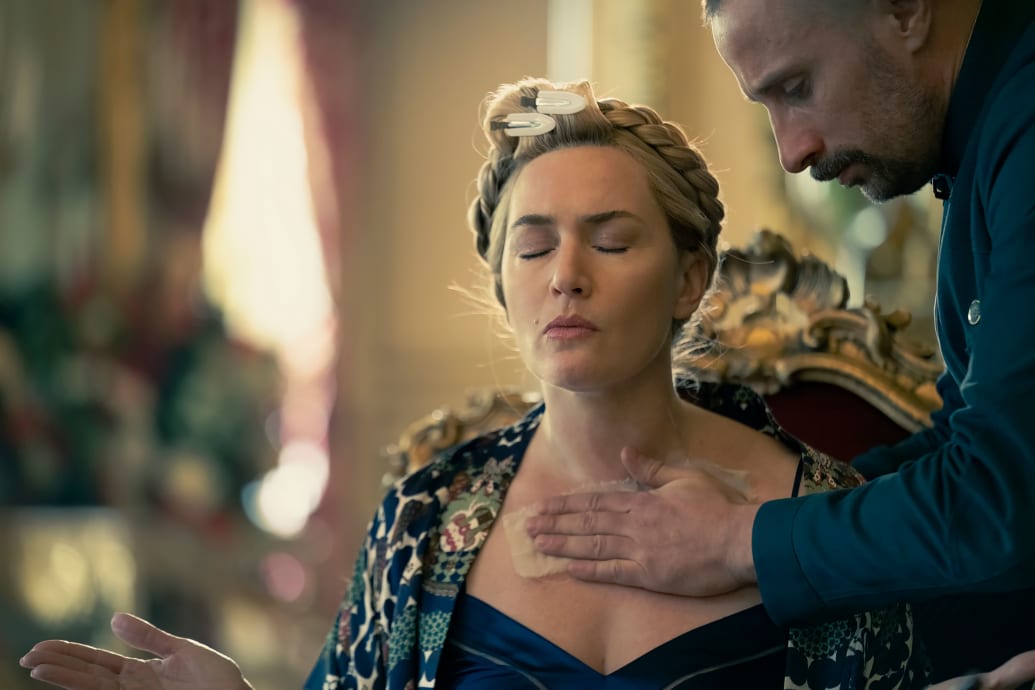 Matthias Schoenaerts pats Kate Winslet’s chest in a still from ‘The Regime’