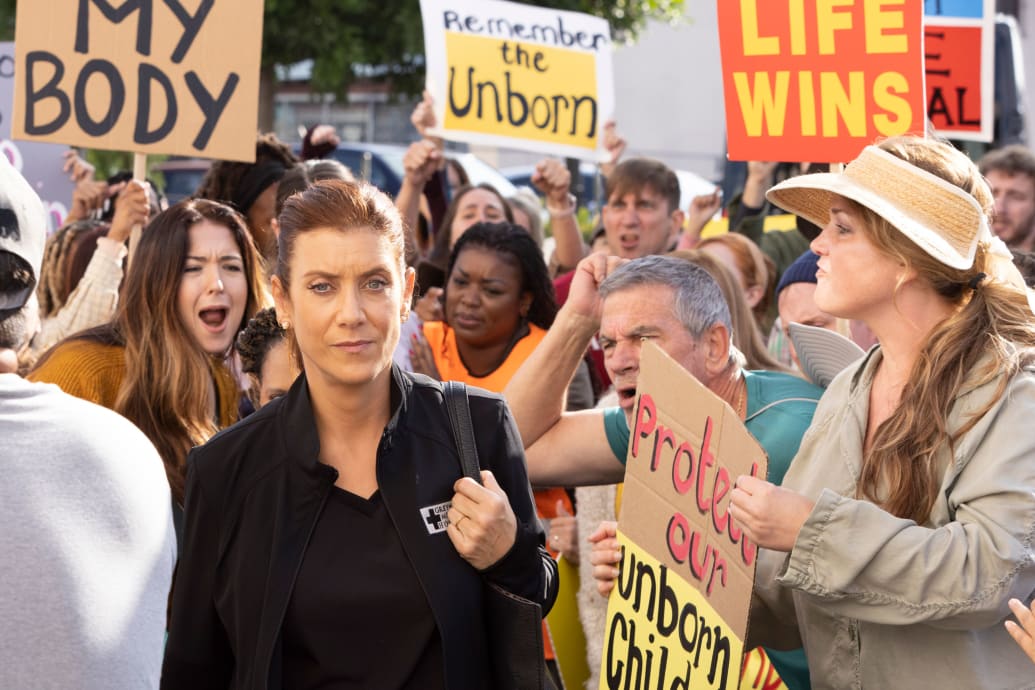 Kate Walsh passes by abortion protestors in a still from 'Grey's Anatomy'