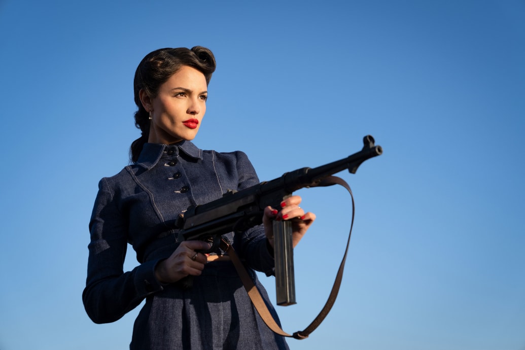 Eiza Gonzalez holds a gun in a still from ‘The Ministry of Ungentlemanly Warfare’