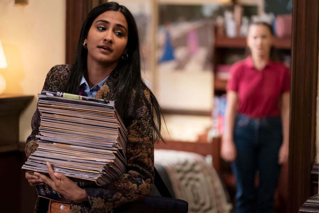 Amrit Kaur carries a stack of books in 'The Sex Lives of College Girls'