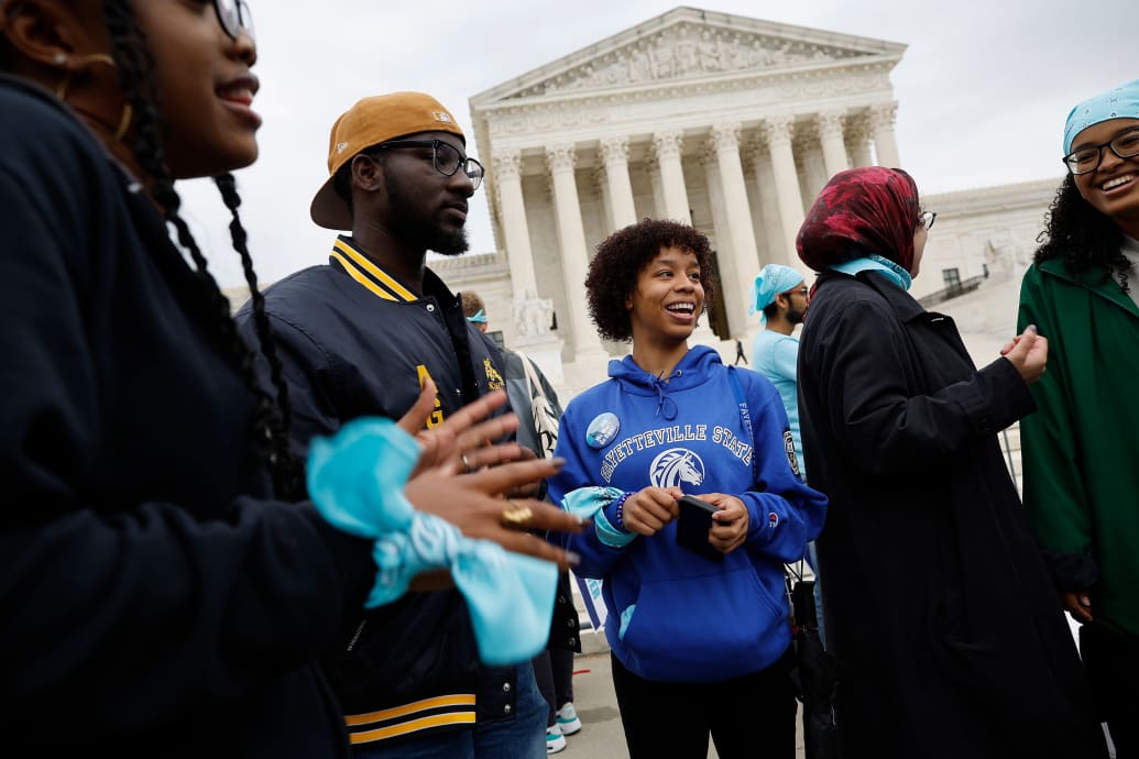 Black students in favor of affirmative action stand outisde of the U.S. Supreme Court