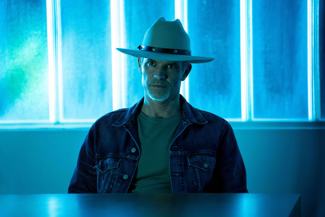 A still from 'Justified: City Primeval' of Timothy Olyphant as Raylan Givens sitting at a table