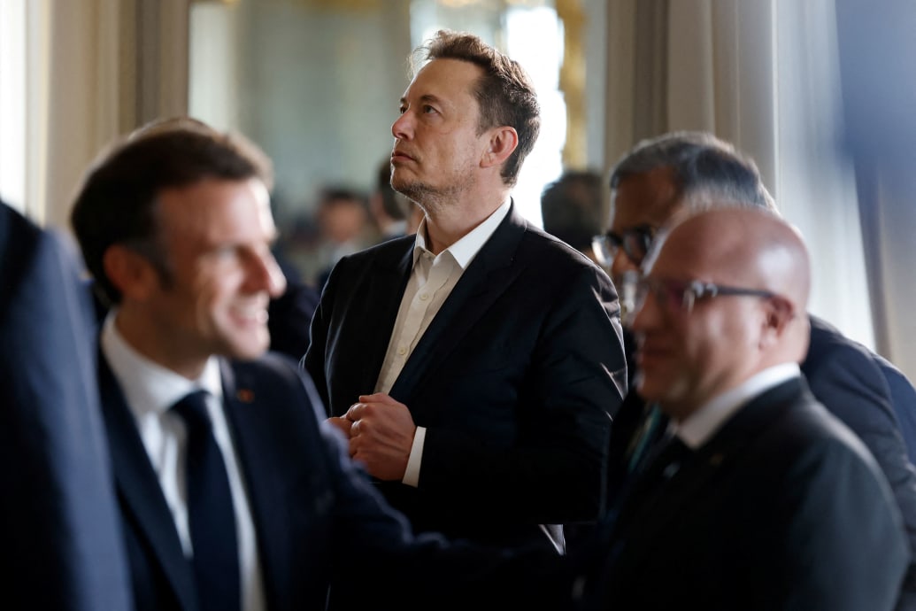 A photo that shows Elon Musk in the background with Emmanuel Macron in the foreground