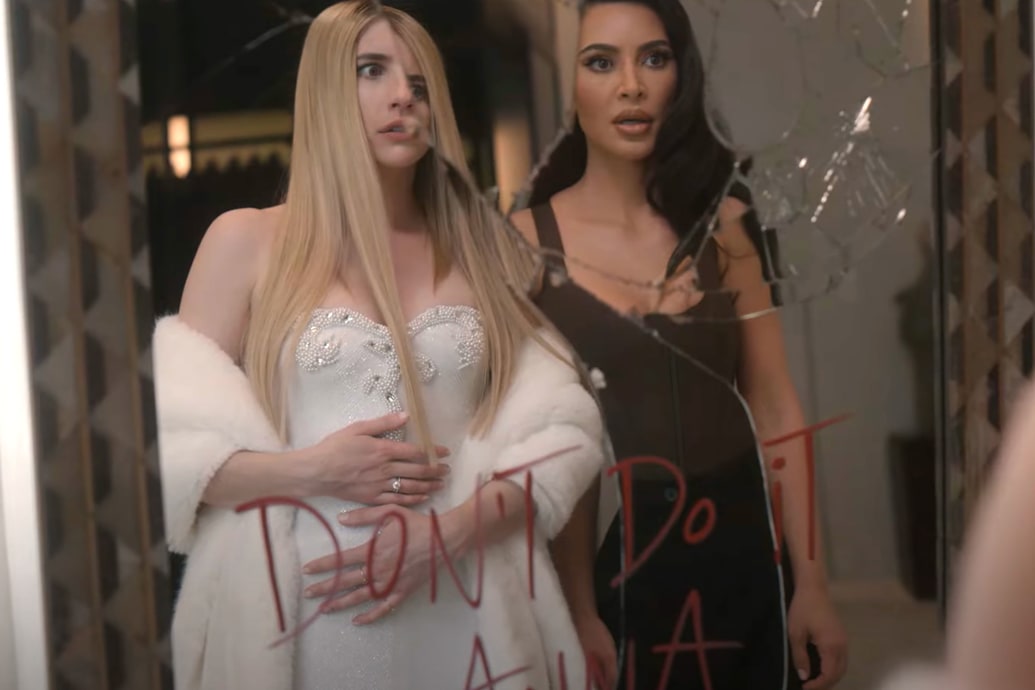 Emma Roberts and Kim Kardashian looking in a broken mirror in a still from American Horror Story: Delicate.