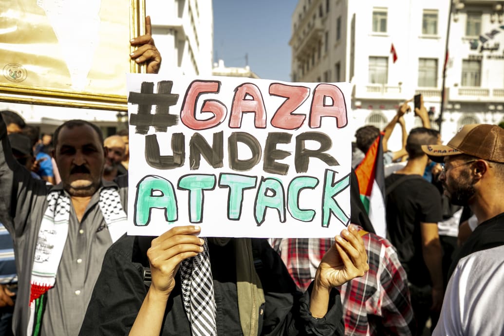 Protesters carry a sign that says “Gaza Under Attack” in Tunisia