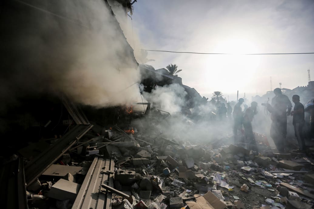A photo of people searching through rubble in Gaza 