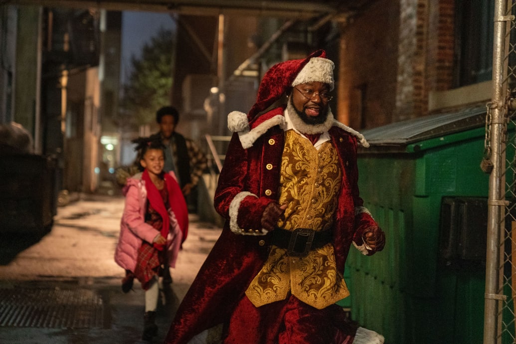 Madison Skye Validum and Chris 'Ludacris' Bridges chase after Lil Rel Howery in a still from 'Dashing Through the Snow'