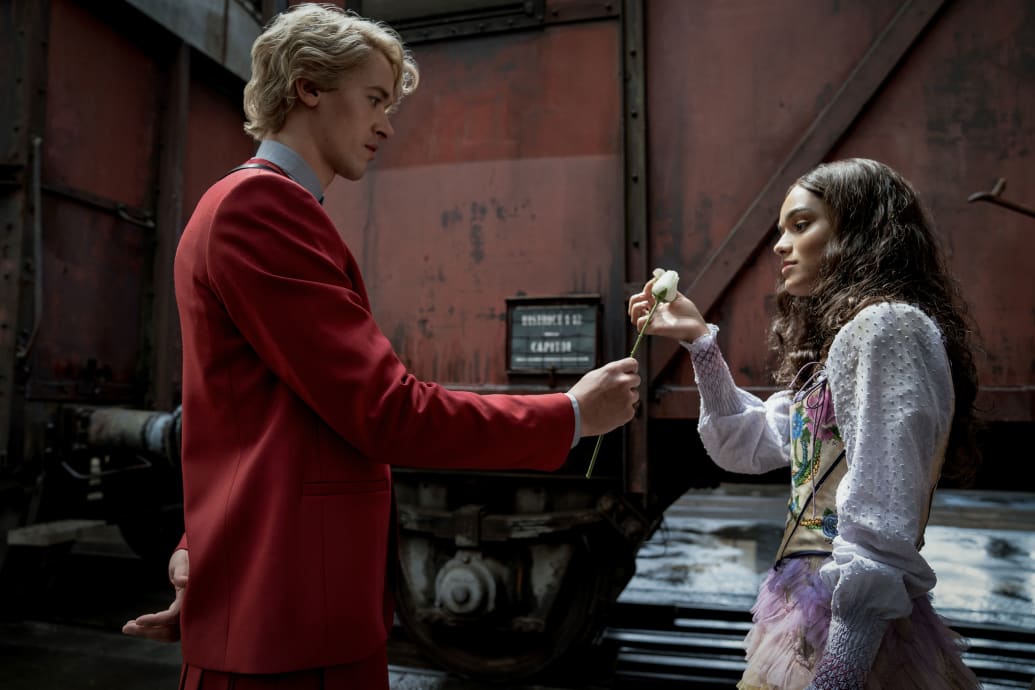 Tom Blyth hands Rachel Zegler a white rose in a still from 'The Hunger Games: The Ballad of Songbirds and Snakes'