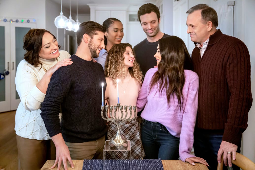 A family gathers around a menorah in 'Eight Gifts of Han