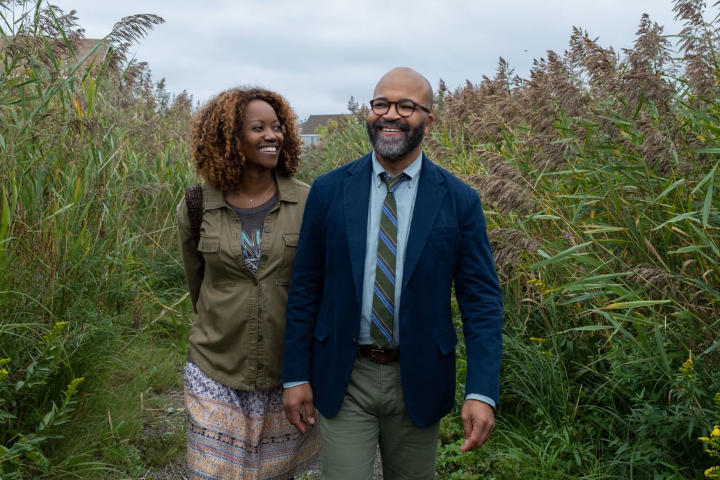 Erika Alexander and Jeffrey Wright walking through a field together in a still from ‘American Fiction’