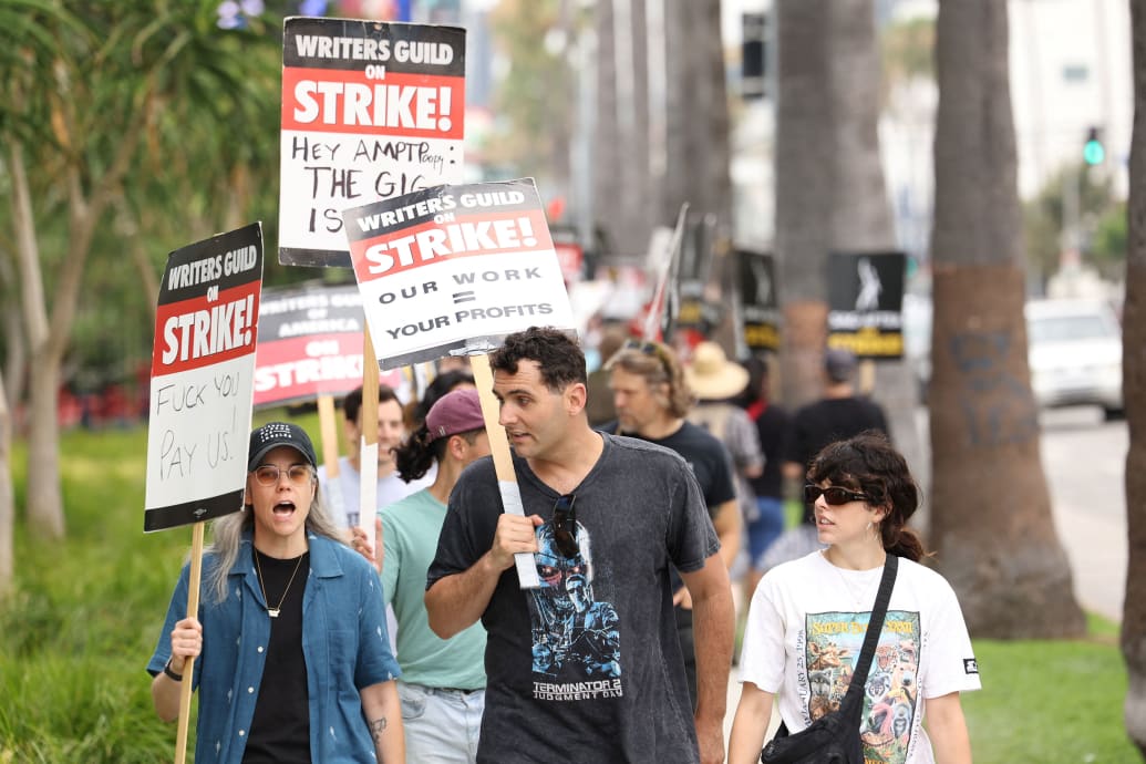 Writers Guild of America protesters march with signs in Los Angeles.
