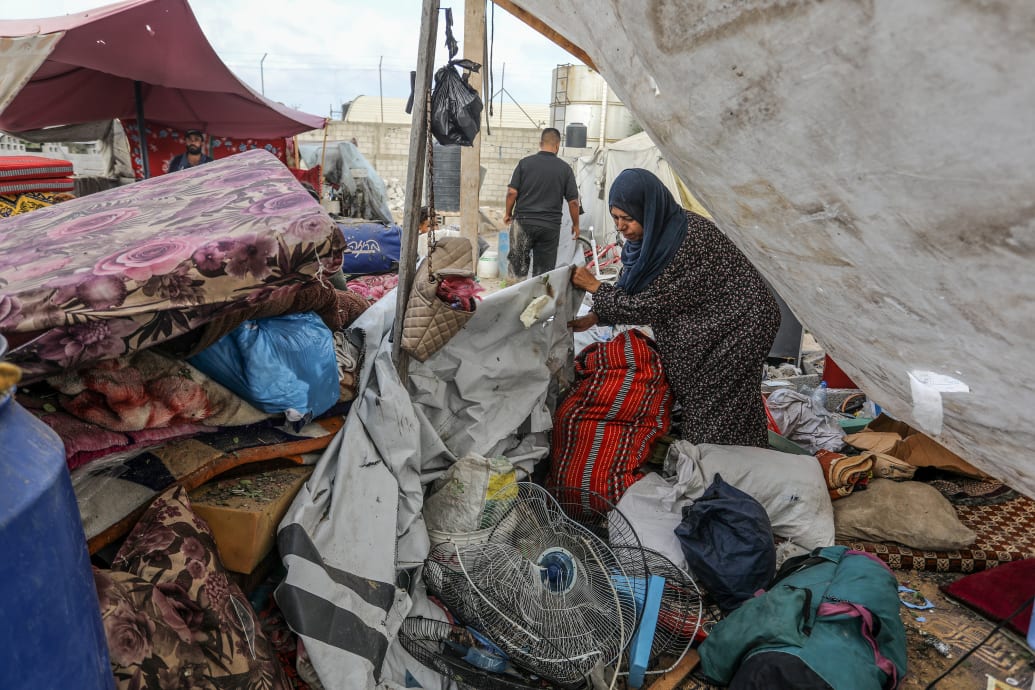 Palestinians inspect damage after an Israeli attack