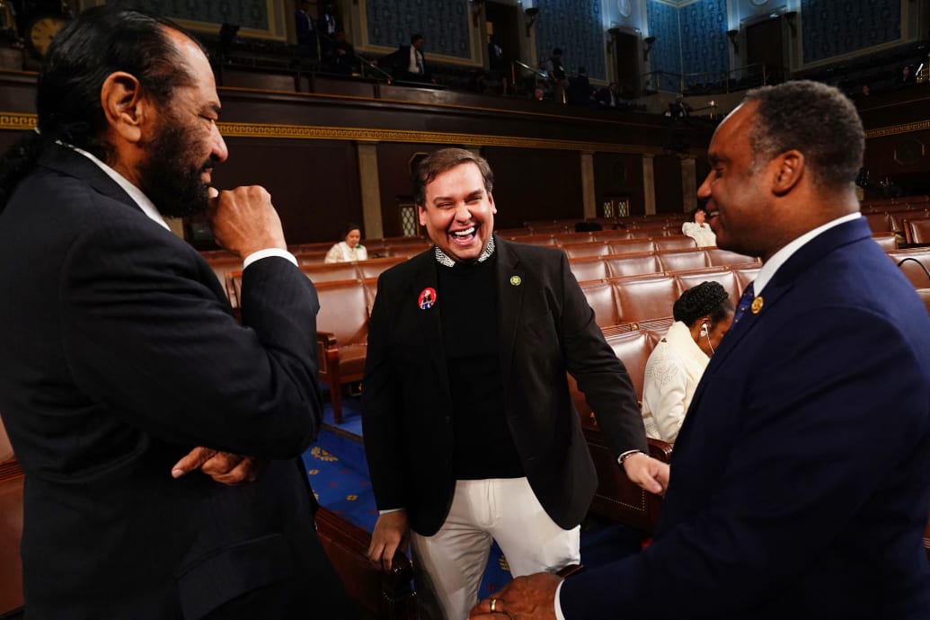 Former Republican Representative from New York George Santos (C) chats with Democratic Representatives Al Green from Texas (L) and Democratic Representative from Illinois Jonathan Jackson (R)