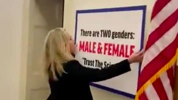 Marjorie Taylor Greene Hangs Anti-Trans Sign Outside Office of  Congresswoman With Trans Daughter