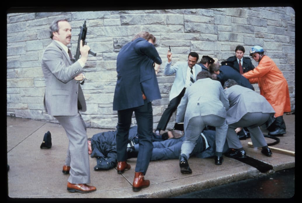 Chaos surrounds shooting victims immediately after the assassination attempt on President Reagan, March 30, 1981, by John Hinckley Jr. outside the Hilton Hotel in Washington, DC.
