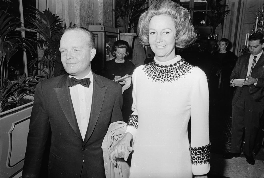 A black and white photo of Truman Capote posing with Katharine Graham at his black and white ball.