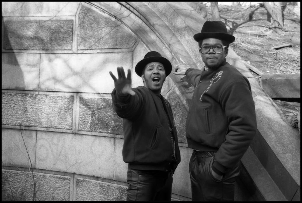 A black and white picture of Joseph "Run" Simmons and Darryl "DMC" McDaniels pose in Central Park.