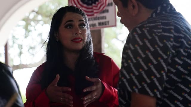 Mayra Flores speaks with voters at a campaign event.