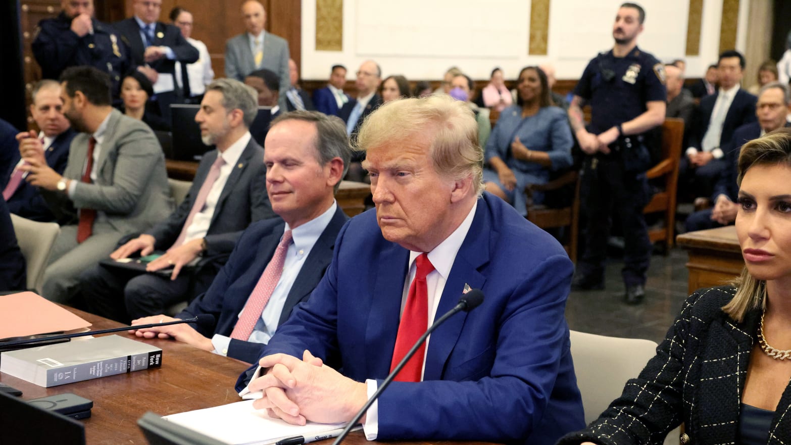 Donald Trump sitting between lawyers in the New York courthouse where his civil fraud trial was held. 