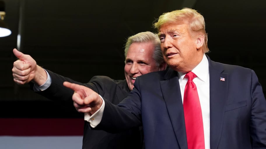 Kevin McCarthy (R-CA) and President Donald Trump react to the crowd as they hold an event on water accessibility for farms during a visit to Bakersfield, California, Feb. 19, 2020.