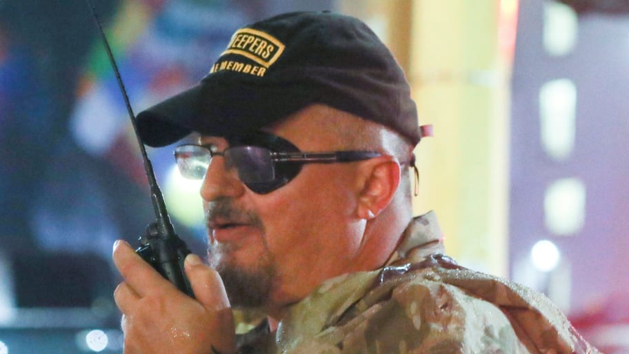 Oath Keepers militia founder Stewart Rhodes uses a radio as he departs with volunteers from a rally held by U.S. President Donald Trump.
