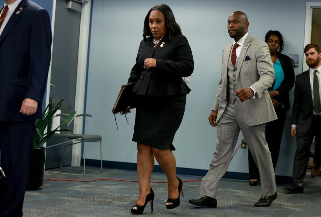 Fulton County District Attorney Fani Willis, trailed by special prosecutor Nathan Wade, arrives at a news conference in August. 