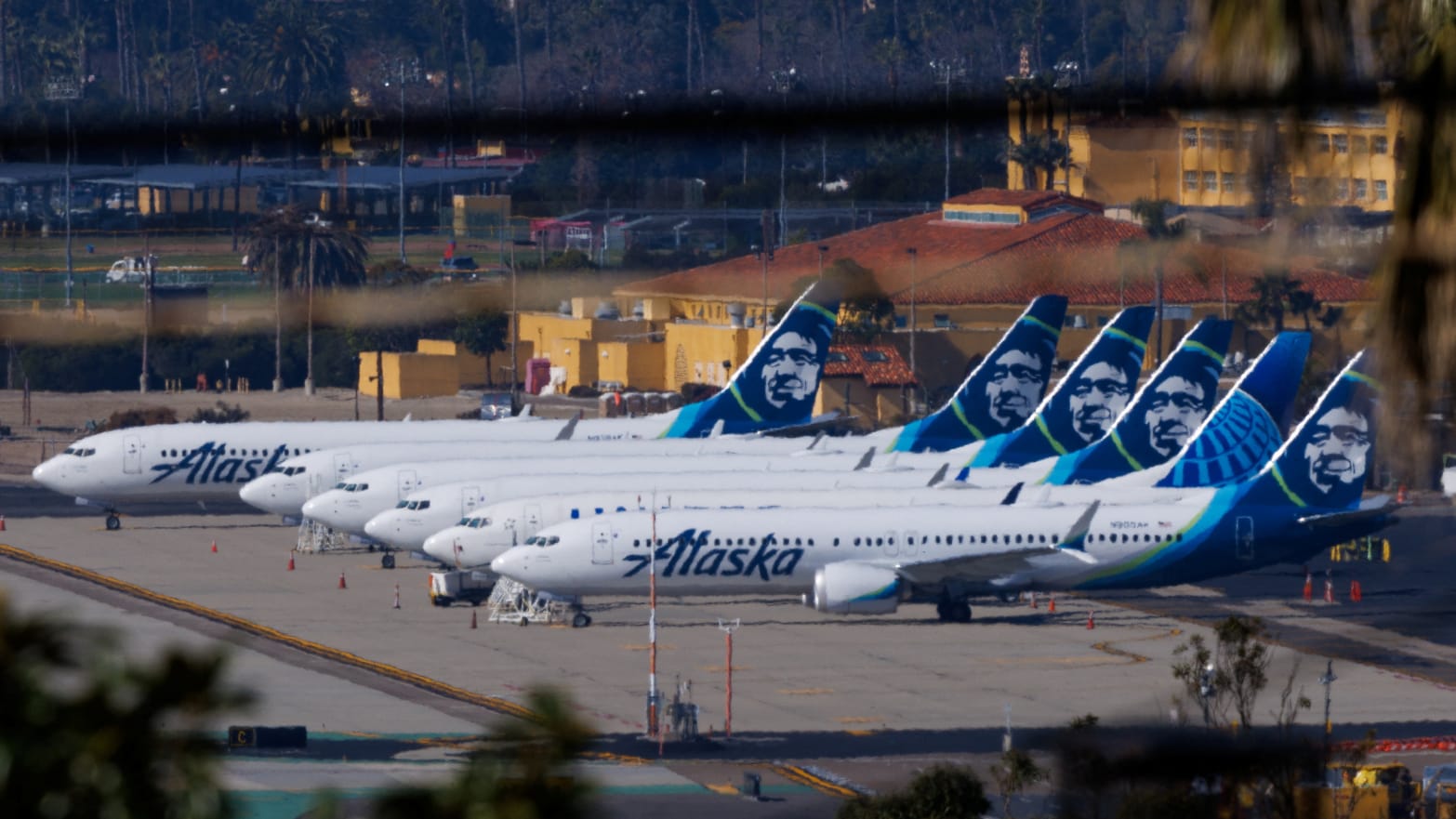 Alaska Airlines commercial airplanes parked off to the side of the airport in San Diego, California.