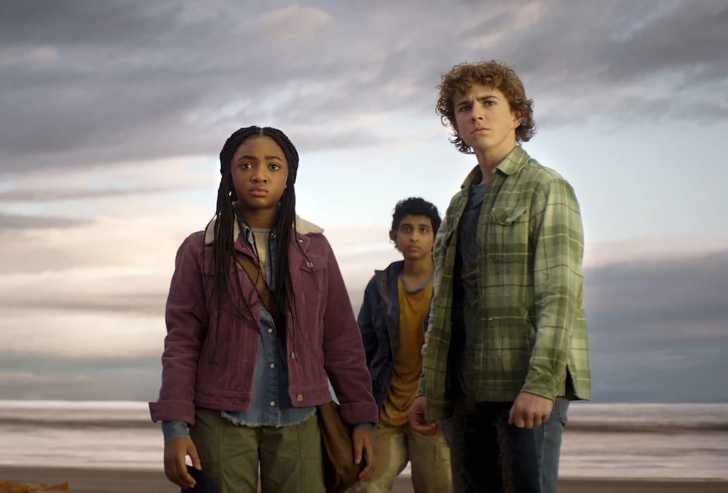 Leah Sava Jeffries, Aryan Simhadri, and Walker Scobell stand in front of a body of water in a still from 'Percy Jackson and the Olympians'