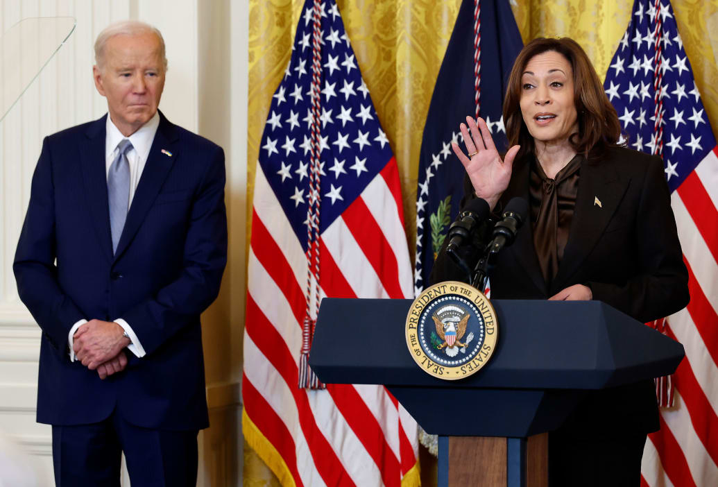 Joe Biden looks on as Kamala Harris speaks.