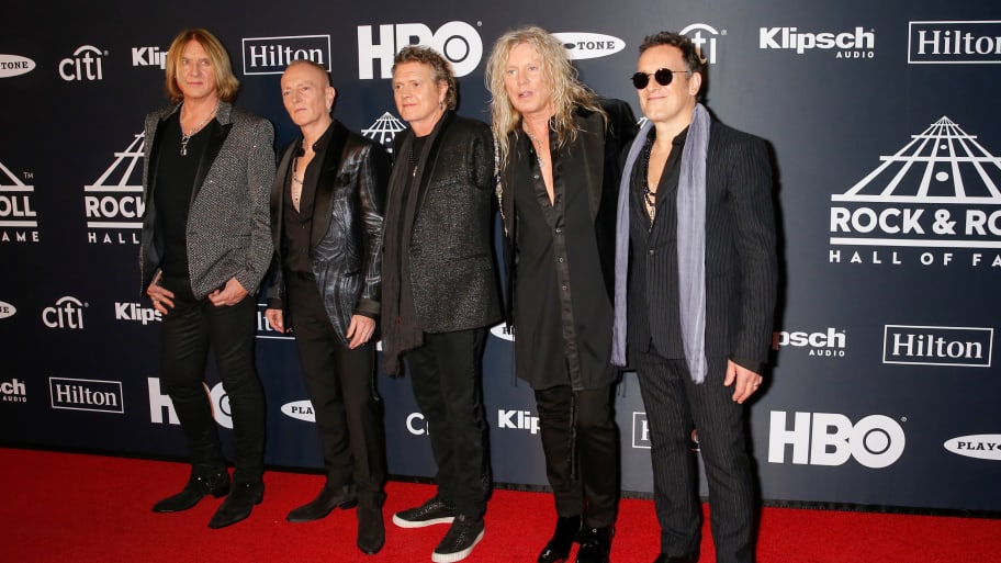 Def Leppard members Joe Elliott, Phil Collen, Rick Allen, Rick Savage and Vivian Campbell on a red carpet