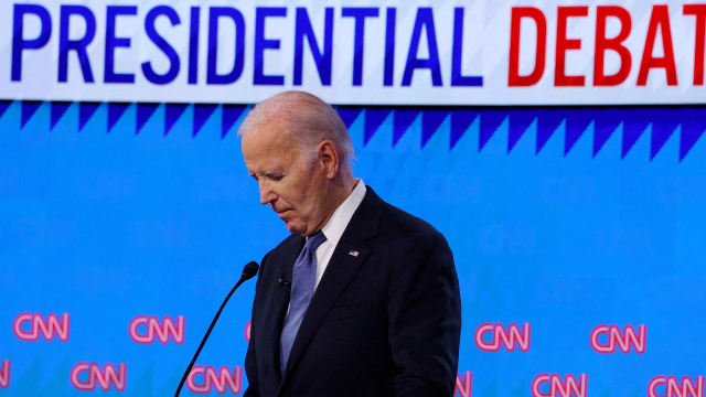 President Joe Biden listens as Republican presidential candidate and former U.S. President Donald Trump speaks during their debate in Atlanta, Georgia.