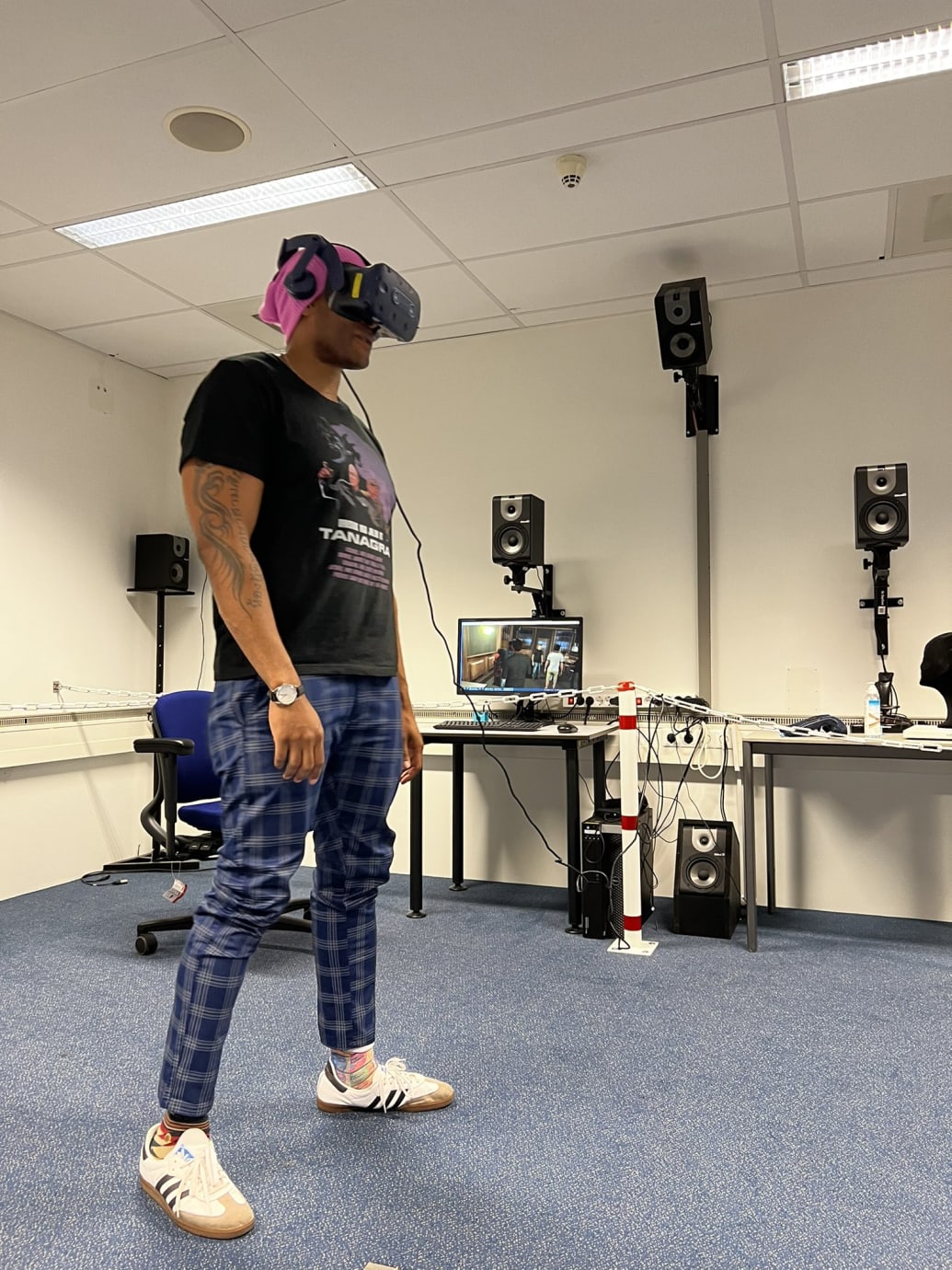 Zeus Tipado stands wearing a VR headset.