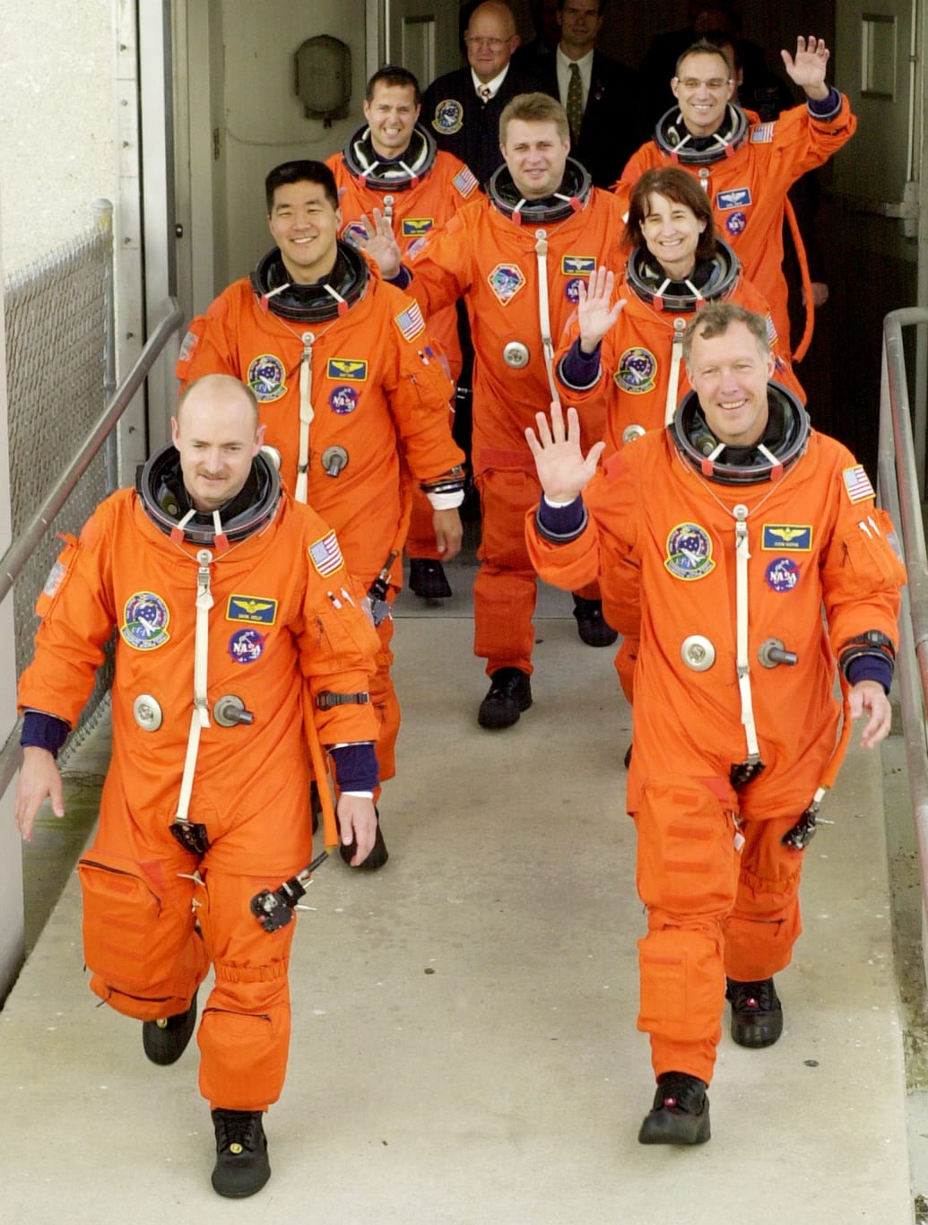 A group of astronauts in orange space suits